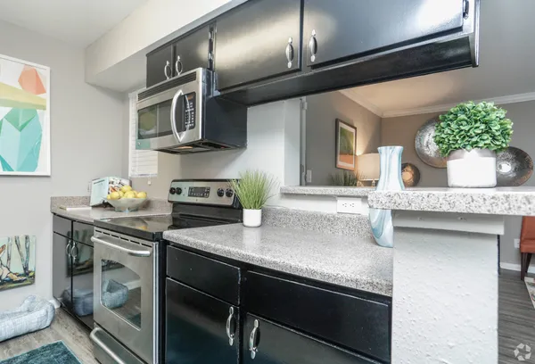a kitchen with a sink appliances and cabinets
