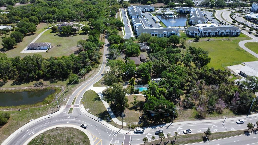 6480 Richardson Road Sarasota, FL 34240 - Photo 4 of 6 an aerial view of a house with a lake view