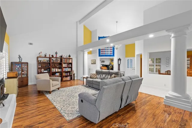 a living room with furniture and a wooden floor