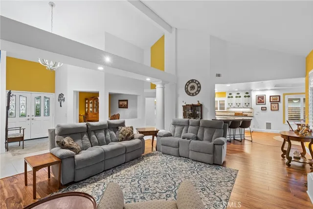 a living room with fireplace furniture and wooden floor