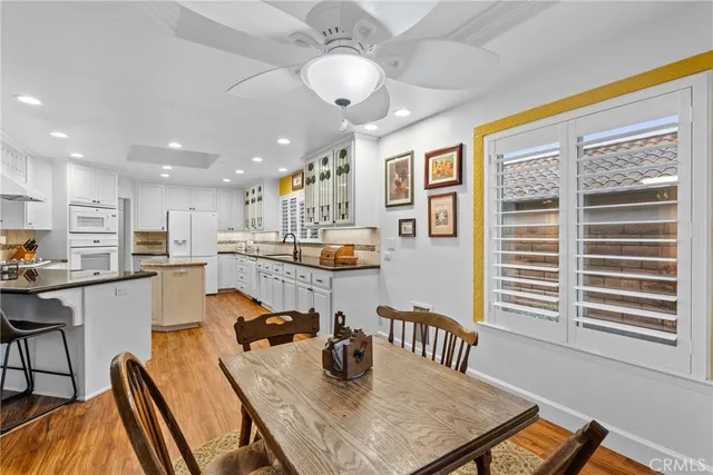 a kitchen with stainless steel appliances granite countertop counter space cabinets dining table and chairs