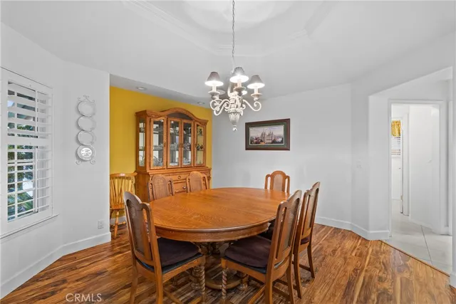 a view of a dining room with furniture and chandelier