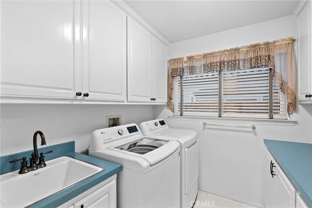 a view of a kitchen with sink and cabinets