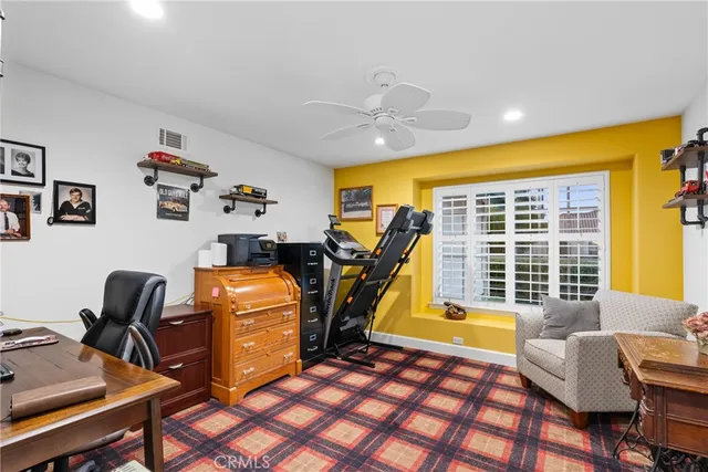 a workspace area with furniture and a window
