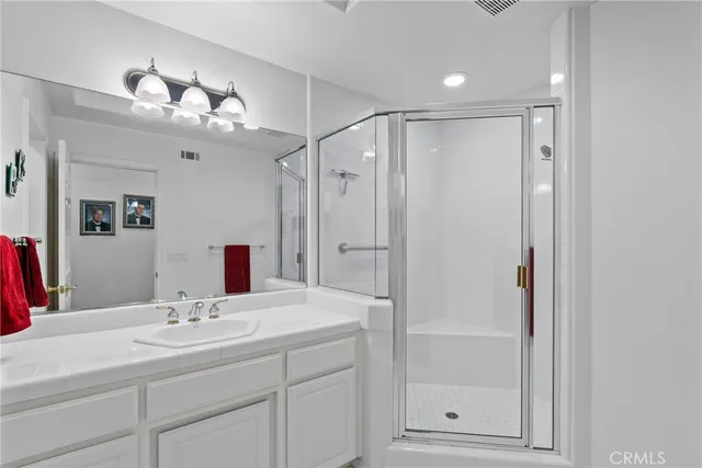 a bathroom with a sink double vanity and a mirror