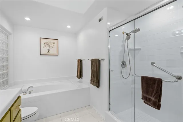 a bathroom with a shower a bath tub and a shower