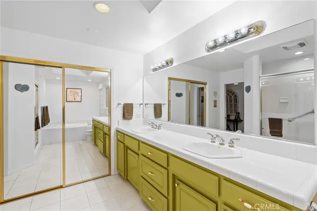 a spacious bathroom with a double vanity sink mirror and shower