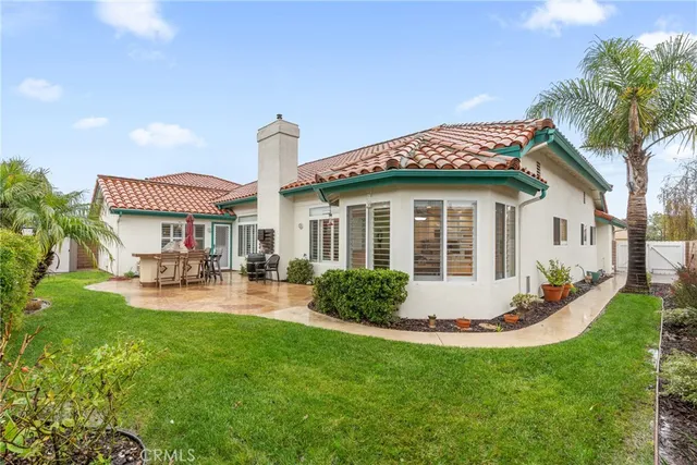 a view of a house with a yard and sitting area