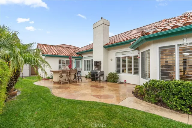 a front view of a house with patio and garden