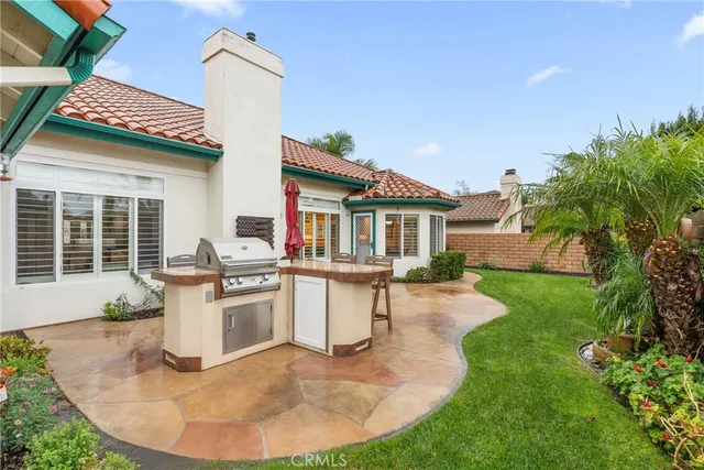 a view of a house with roof deck and sitting area
