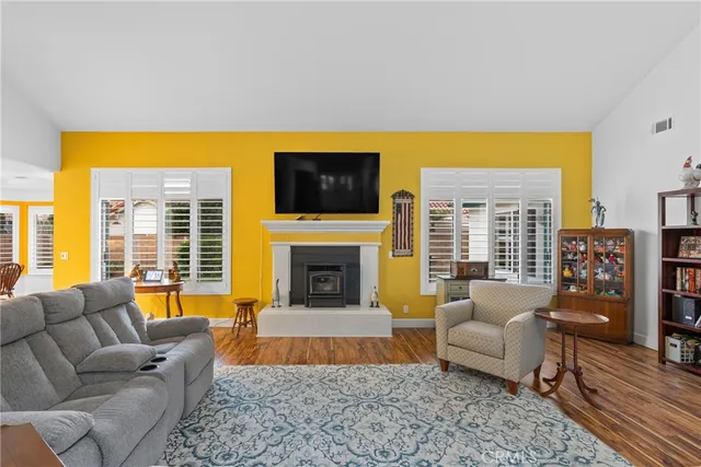 a living room with fireplace furniture and a flat screen tv
