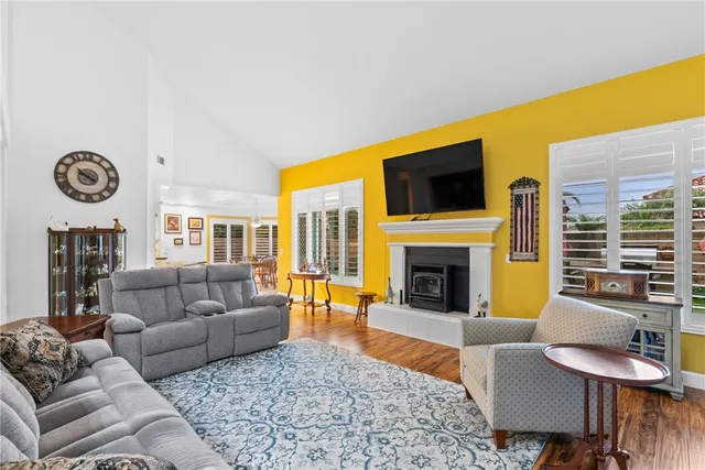 a living room with fireplace furniture and a flat screen tv