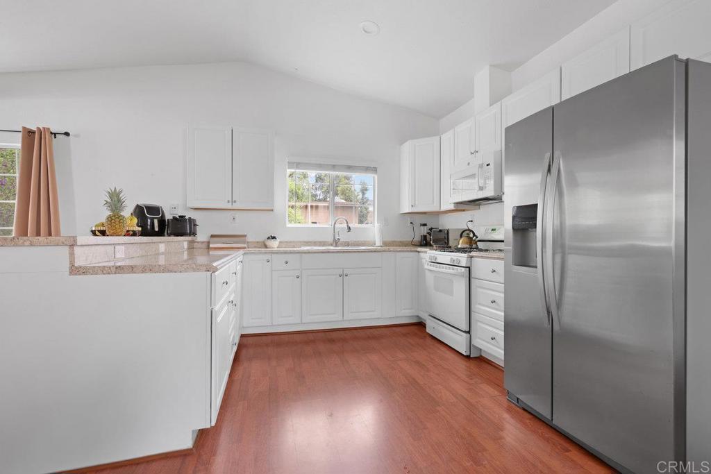 8968 Lakeview Road Lakeside, CA 92040 - Photo 14 of 30 a kitchen with white cabinets and white appliances