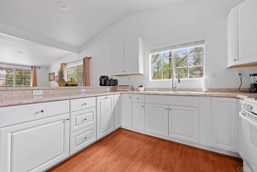 8968 Lakeview Road Lakeside, CA 92040 - Photo 16 of 30 a kitchen with white cabinets window and sink