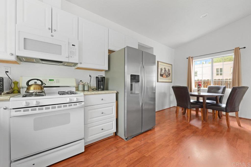 8968 Lakeview Road Lakeside, CA 92040 - Photo 17 of 30 a kitchen with white cabinets and stainless steel appliances