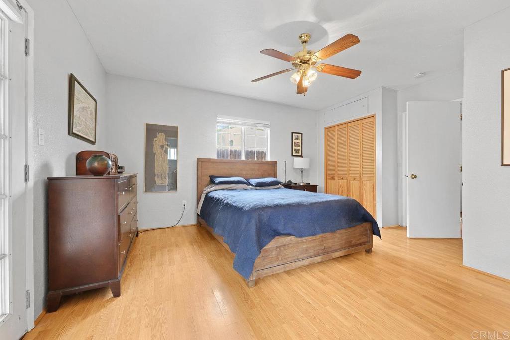 8968 Lakeview Road Lakeside, CA 92040 - Photo 23 of 30 a spacious bedroom with a bed and a ceiling fan