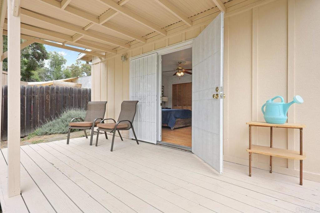 8968 Lakeview Road Lakeside, CA 92040 - Photo 6 of 30 a view of a patio with table and chairs with wooden floor and fence