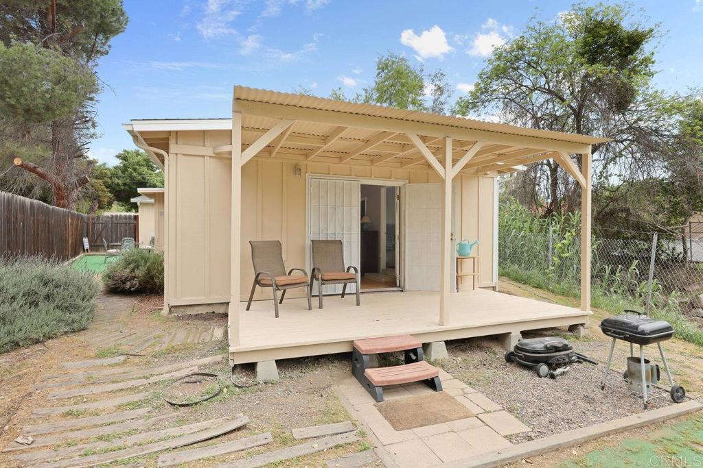 8968 Lakeview Road Lakeside, CA 92040 - Photo 7 of 30 a view of a patio with table and chairs potted plants with wooden floor and fence