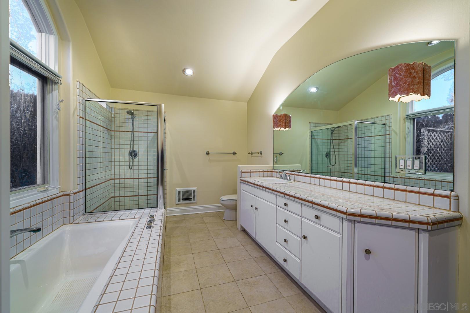 6531 Lago Lindo Rancho Santa Fe, CA 92067 - Photo 12 of 54 a bathroom with a granite countertop sink mirror and bathtub