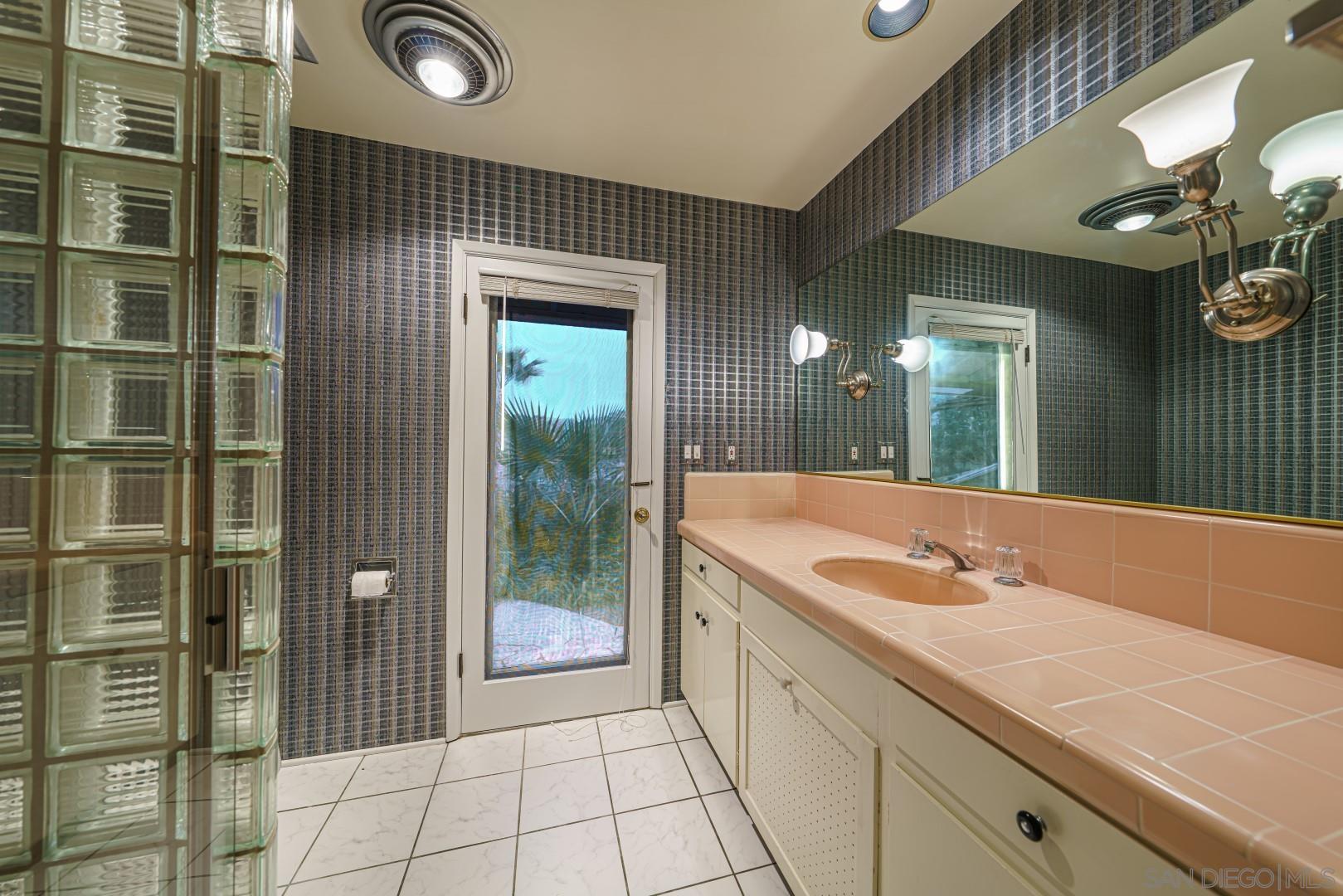 6531 Lago Lindo Rancho Santa Fe, CA 92067 - Photo 14 of 54 a spacious bathroom with a granite countertop sink a mirror and shower