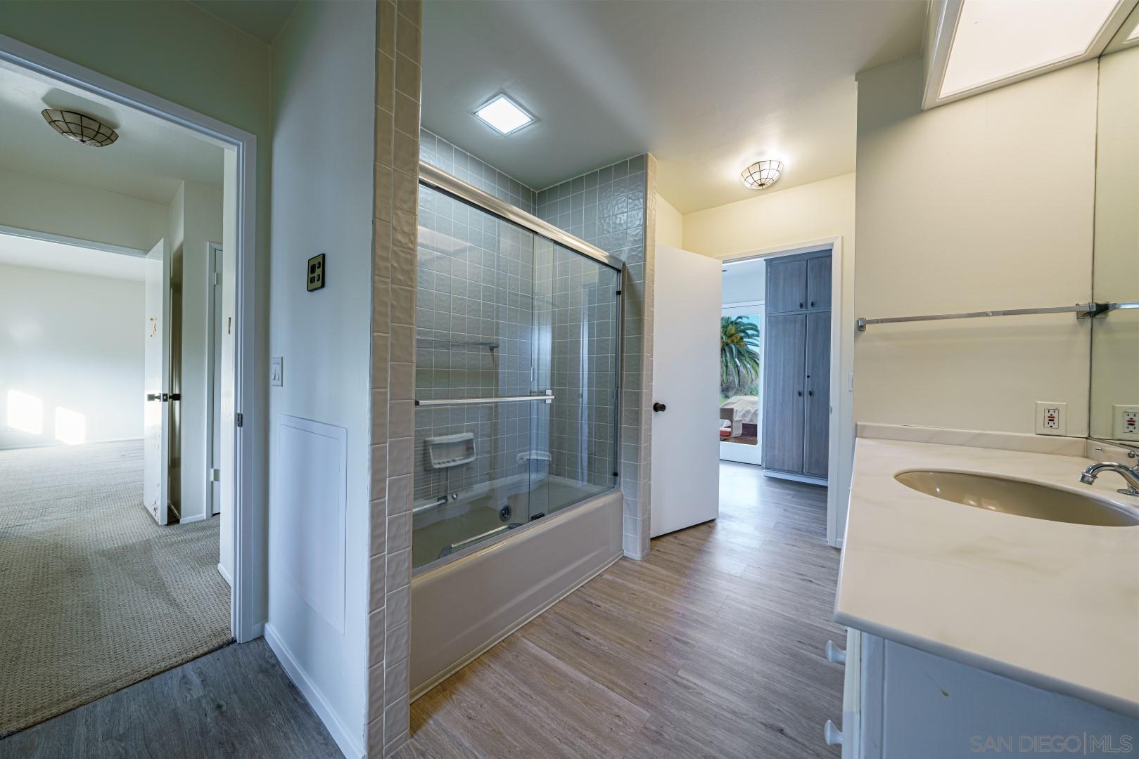 6531 Lago Lindo Rancho Santa Fe, CA 92067 - Photo 16 of 54 a bathroom with a sink and a glass door shower