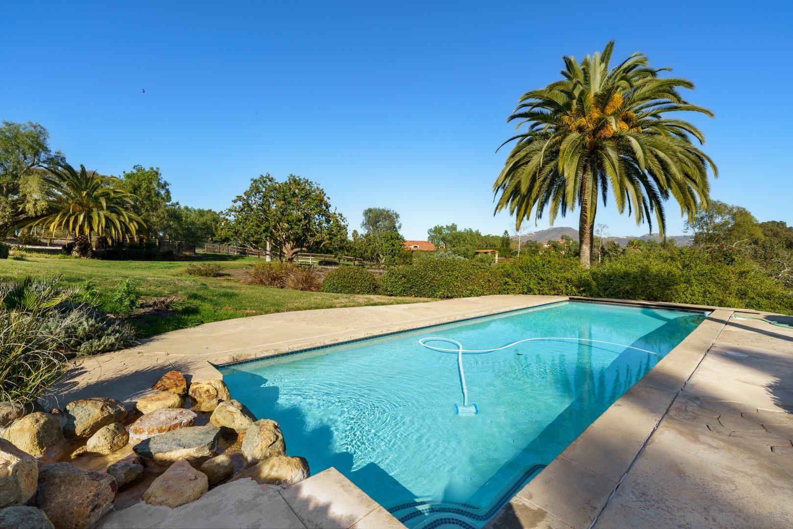 6531 Lago Lindo Rancho Santa Fe, CA 92067 - Photo 20 of 54 a view of a yard with an umbrella