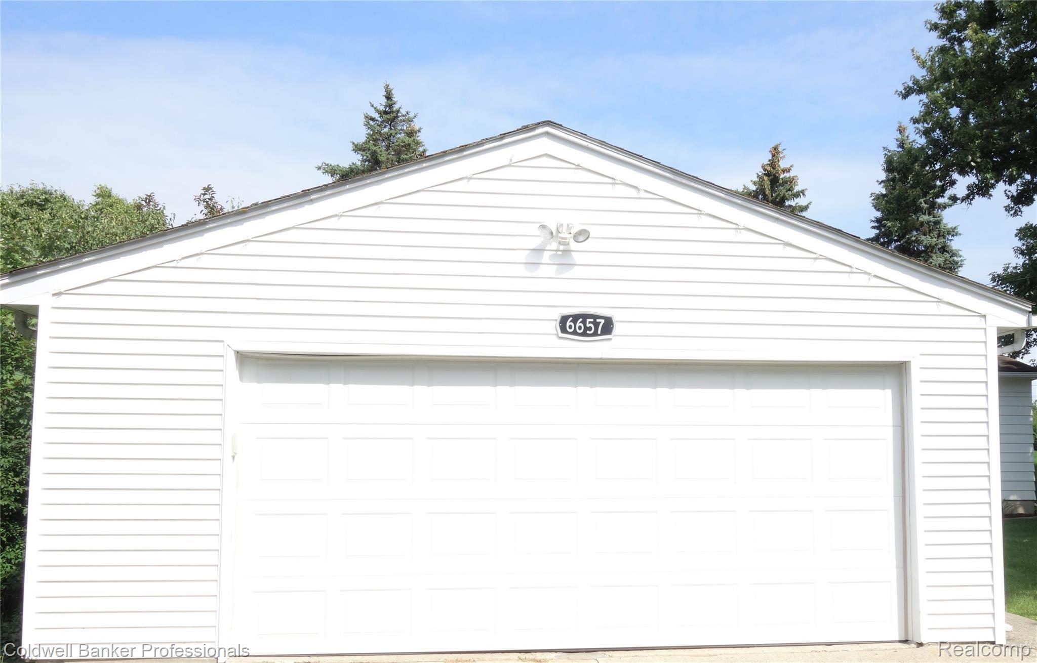 6657 Waldon Road Clarkston, MI 48346 - Photo 9 of 27 2+ car garage with remote garage door opener, out lighting and electricity