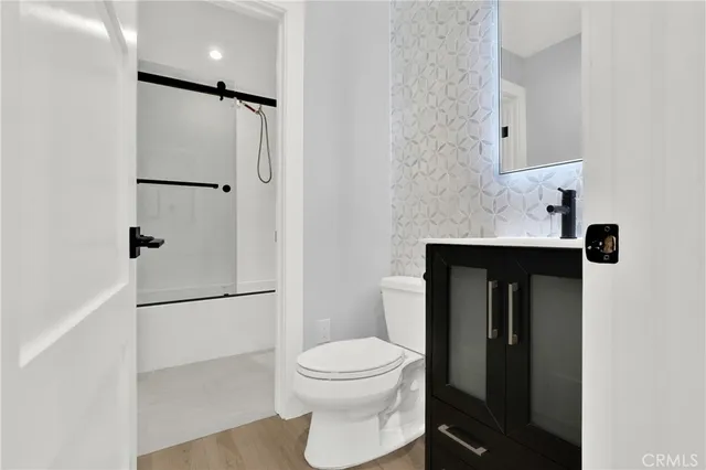 a bathroom with a toilet a sink and shower