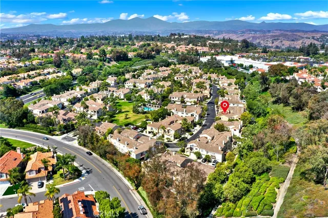 an aerial view of residential houses with outdoor space