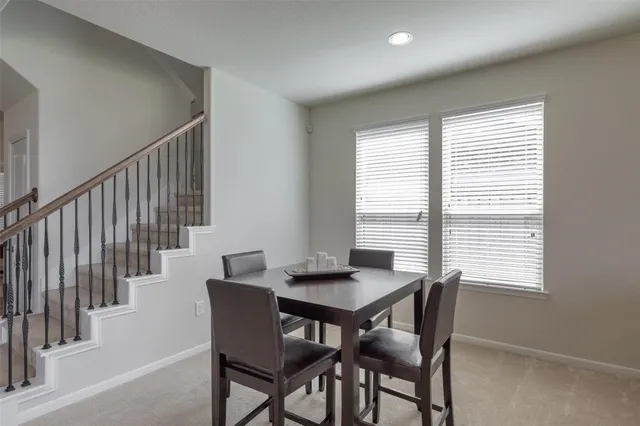 a view of a dining room with furniture and a window