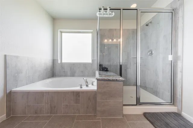 a bathroom with a bathtub and a shower