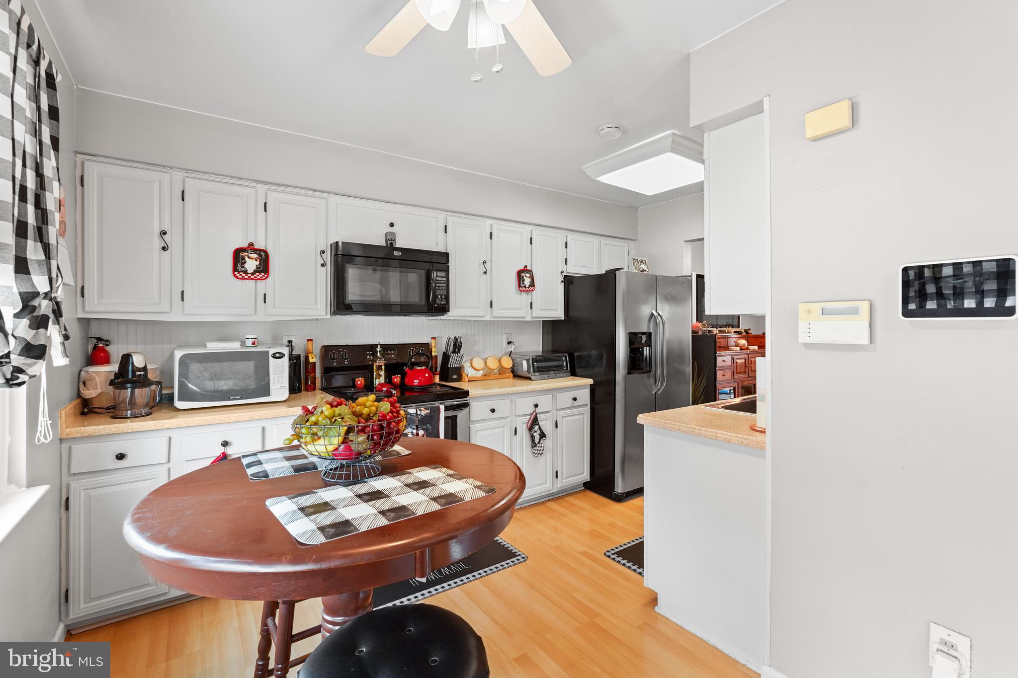 5210 Vienna Drive Clinton, MD 20735 - Photo 11 of 29 a kitchen with stainless steel appliances kitchen island granite countertop a sink and cabinets