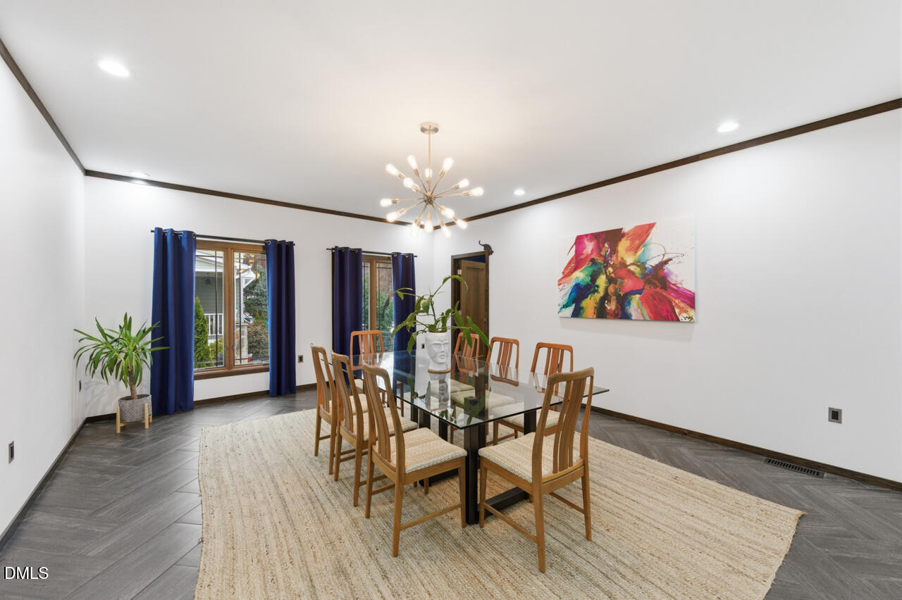 3315 Denada Path Durham, NC 27707 - Photo 23 of 74 a view of a dining room with furniture wooden floor and chandelier