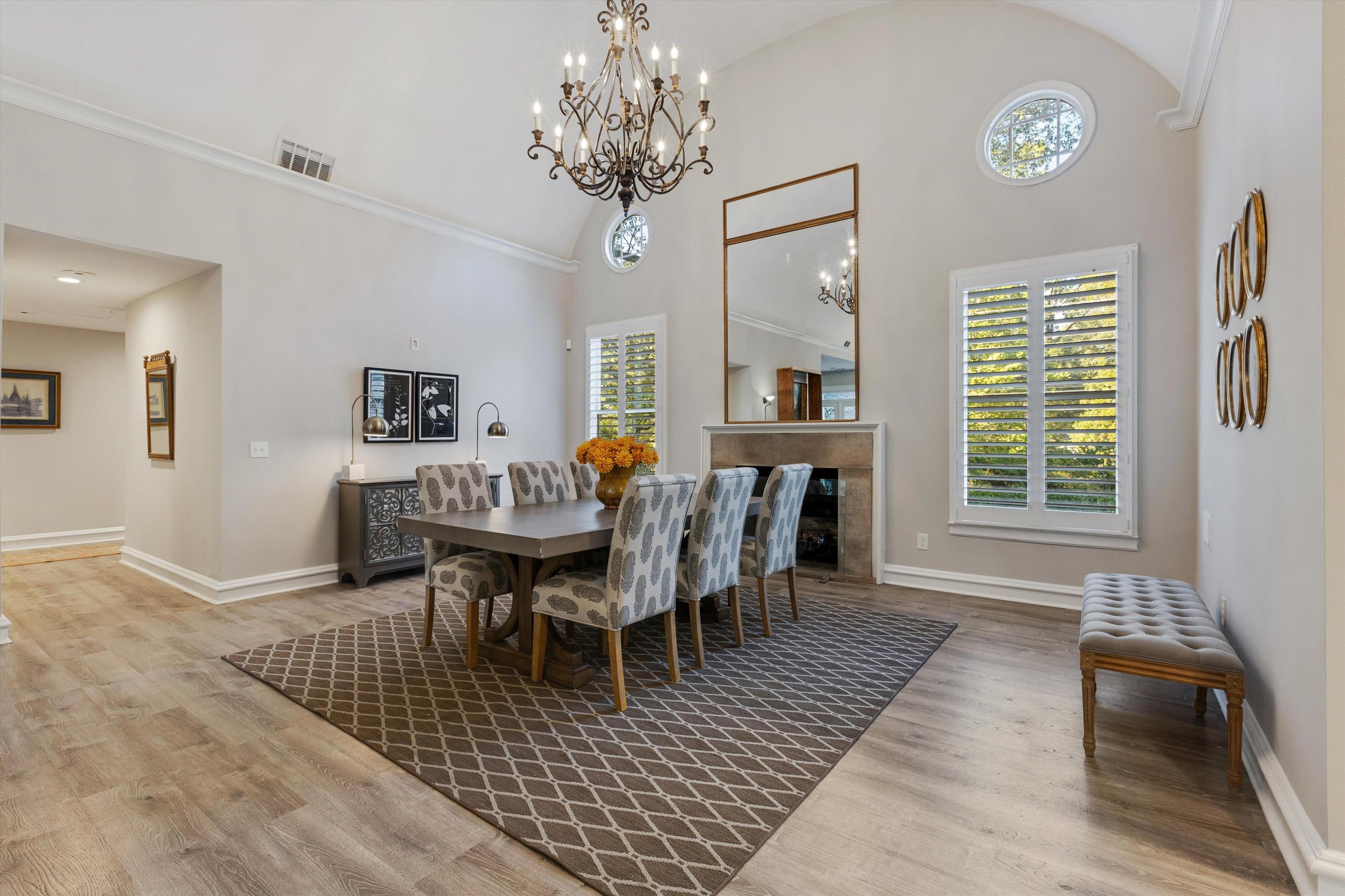194 South Perkins Road Memphis, TN 38117 - Photo 16 of 33 a dining room with wooden floor a chandelier a wooden table and chairs