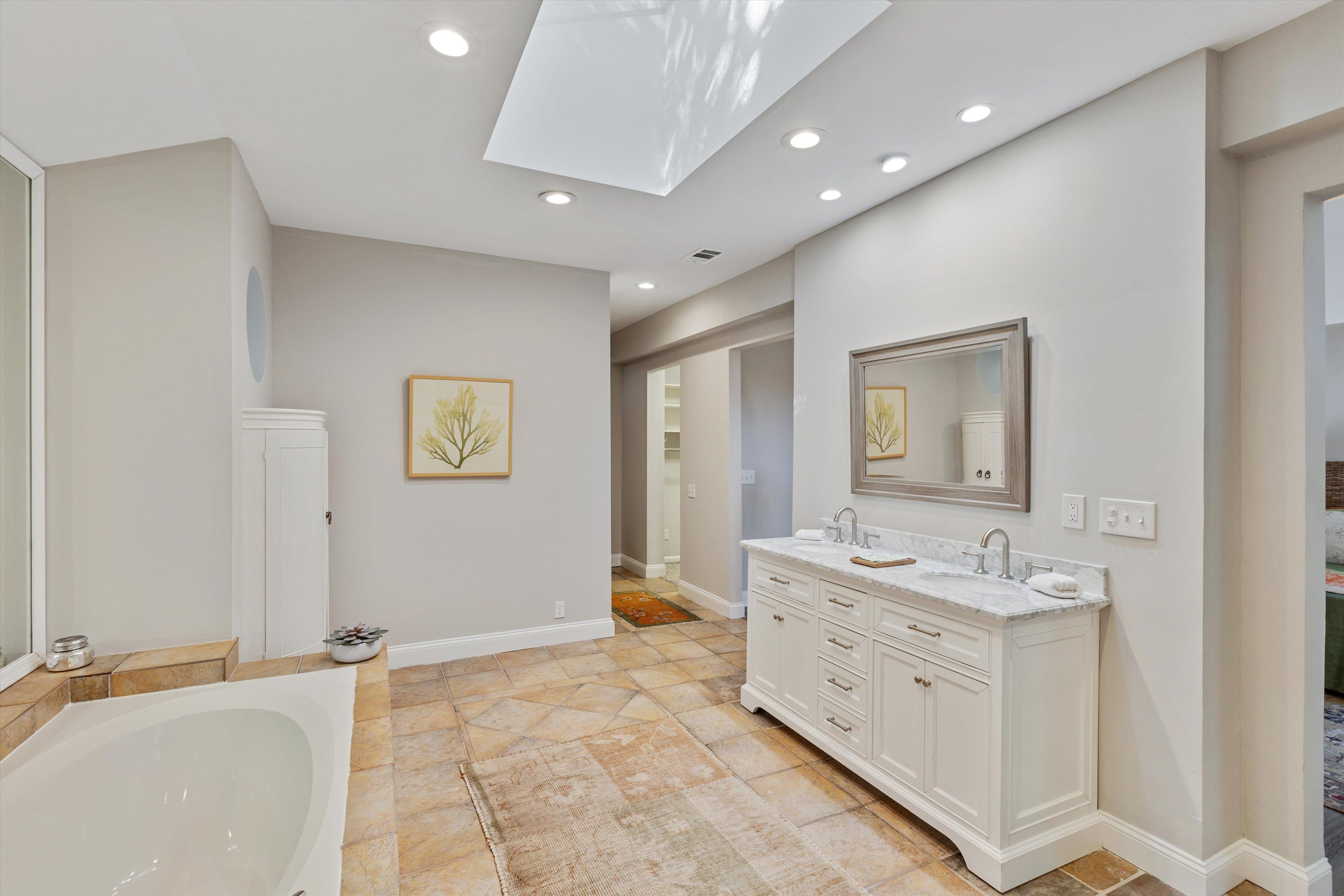 194 South Perkins Road Memphis, TN 38117 - Photo 22 of 33 a bathroom with a granite countertop sink a mirror and a bathtub