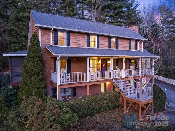 a front view of a house with porch and outdoor seating