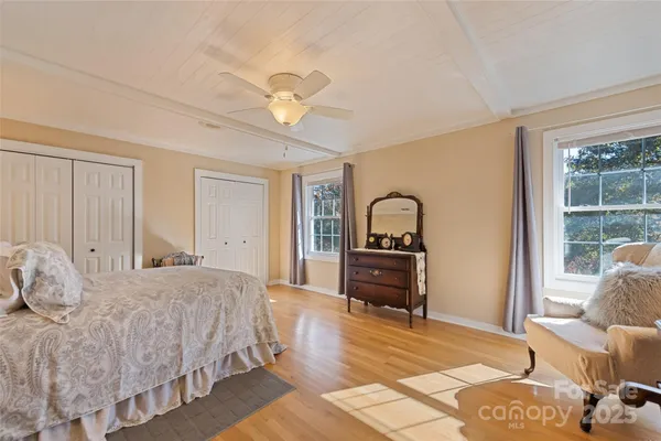 a bedroom with furniture and wooden floor