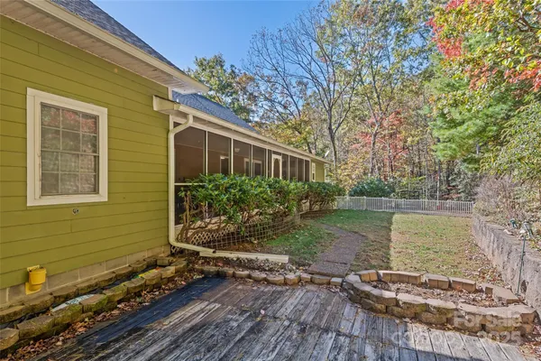 a view of a backyard with wooden fence