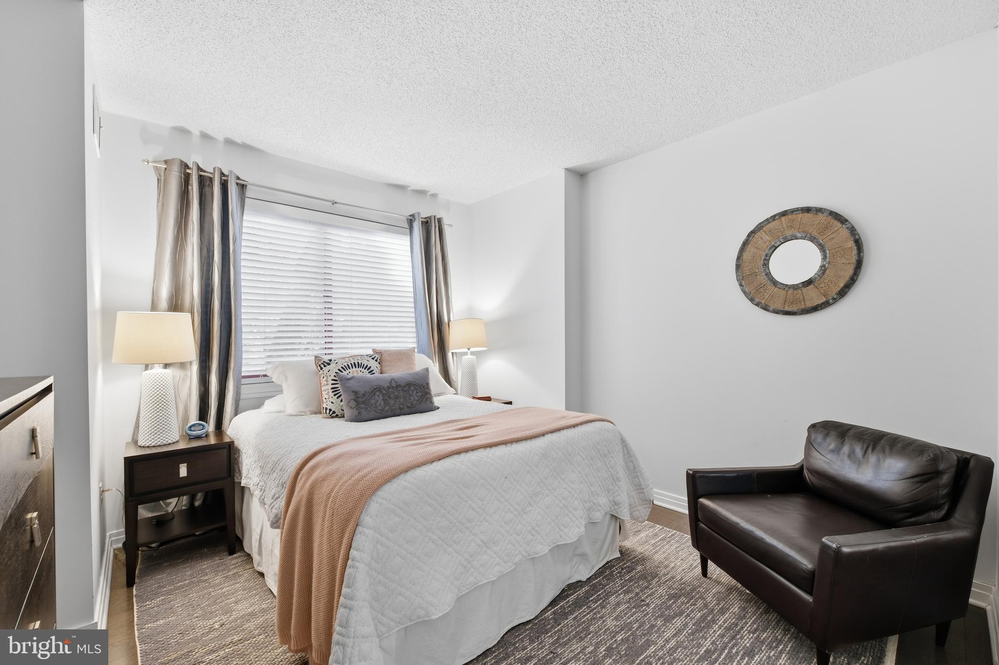 2301 N Street Northwest, Unit 212 Washington, DC 20037 - Photo 11 of 23 a bedroom with a bed couch and a window
