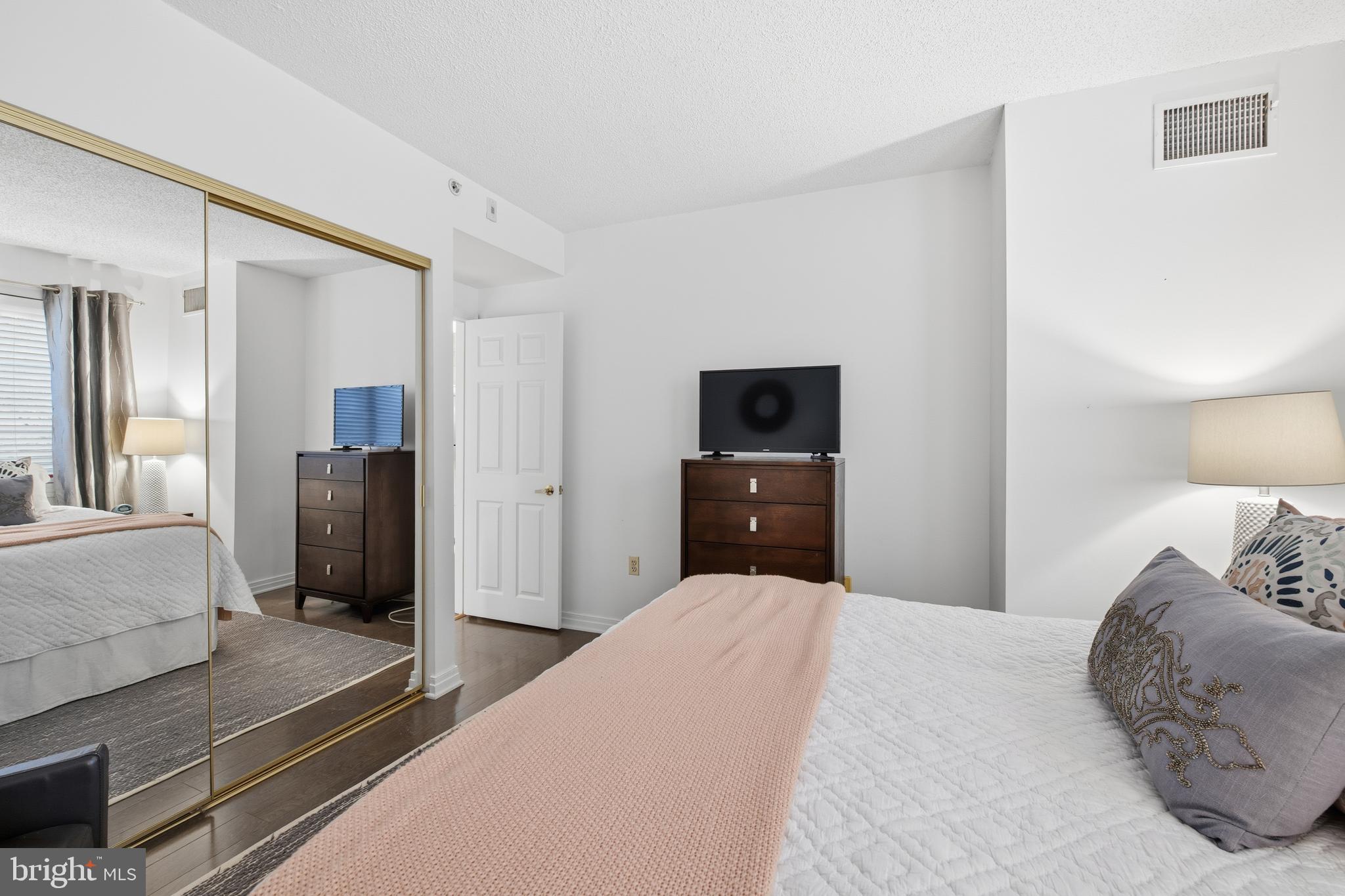 2301 N Street Northwest, Unit 212 Washington, DC 20037 - Photo 12 of 23 a bedroom with a bed and a television