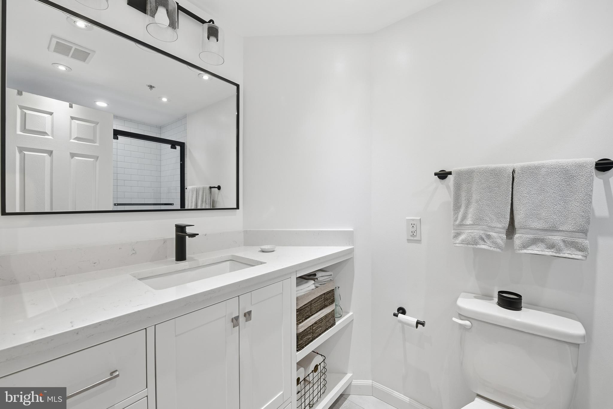 2301 N Street Northwest, Unit 212 Washington, DC 20037 - Photo 13 of 23 a bathroom with a sink a toilet and mirror