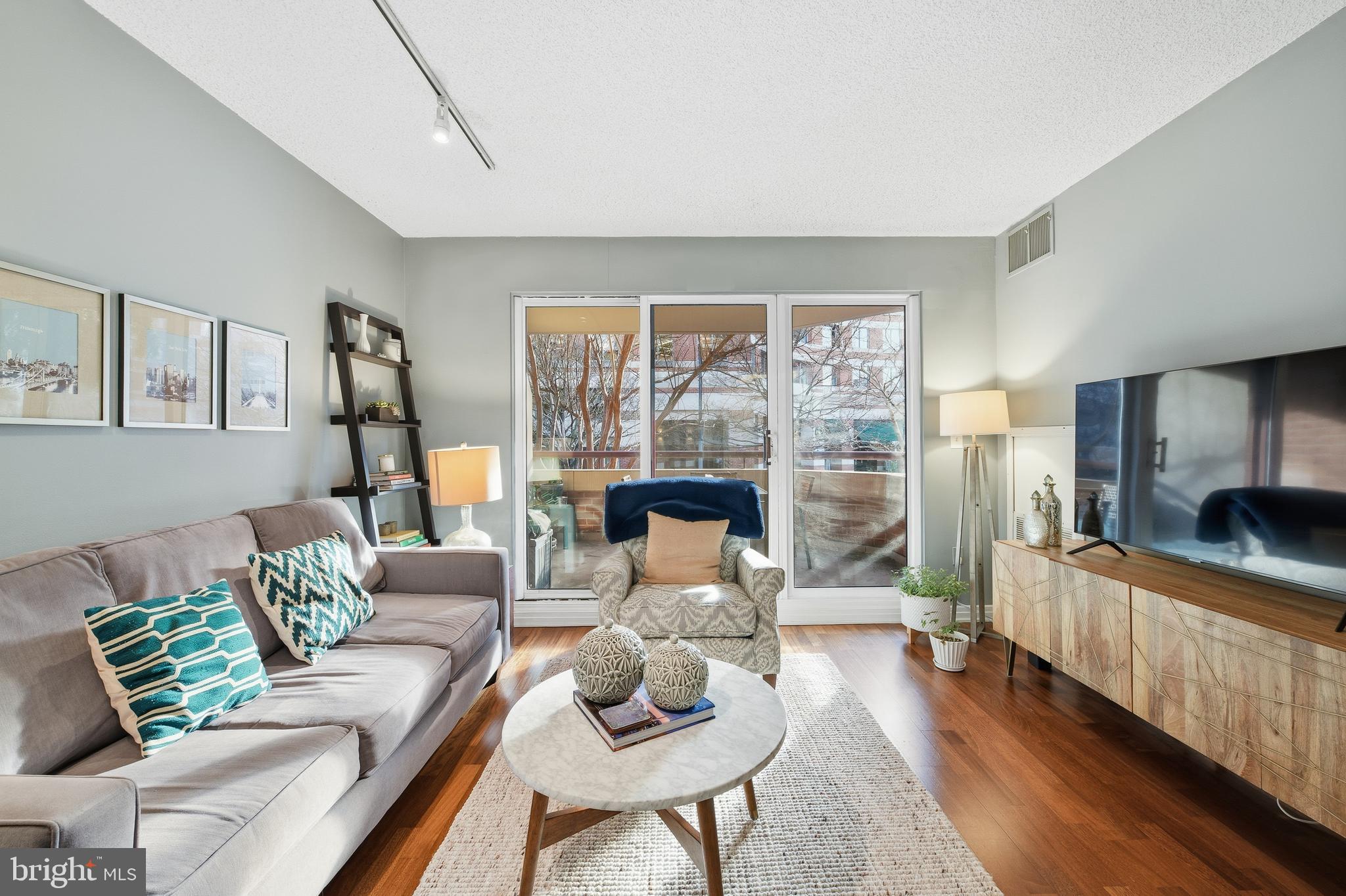 2301 N Street Northwest, Unit 212 Washington, DC 20037 - Photo 2 of 23 a living room with furniture and a large window