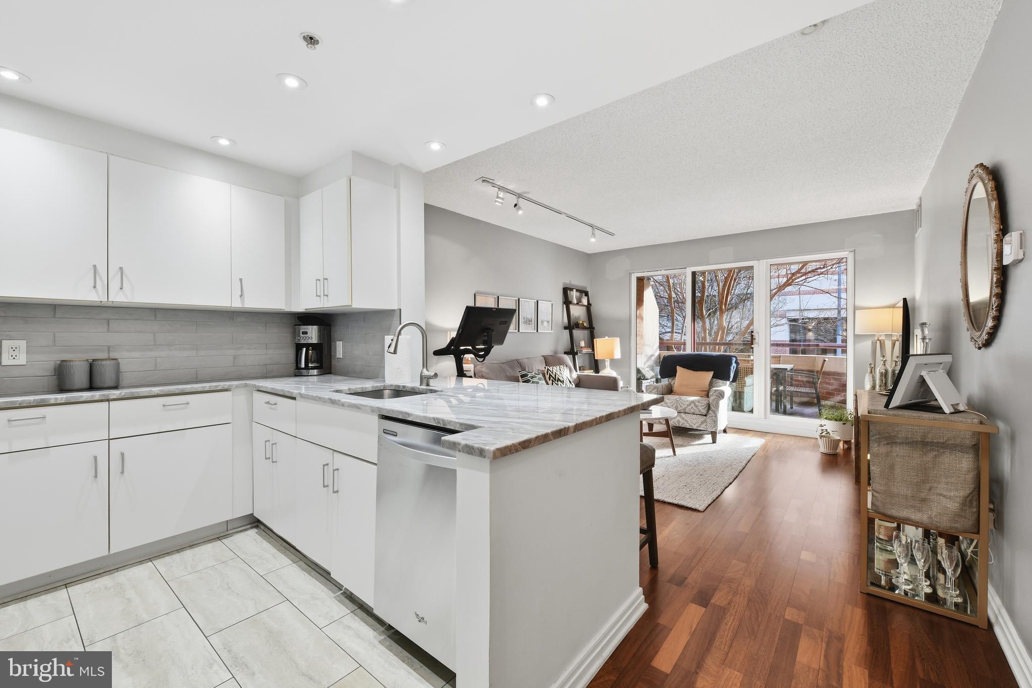 2301 N Street Northwest, Unit 212 Washington, DC 20037 - Photo 7 of 23 a kitchen with granite countertop a sink stove and cabinets