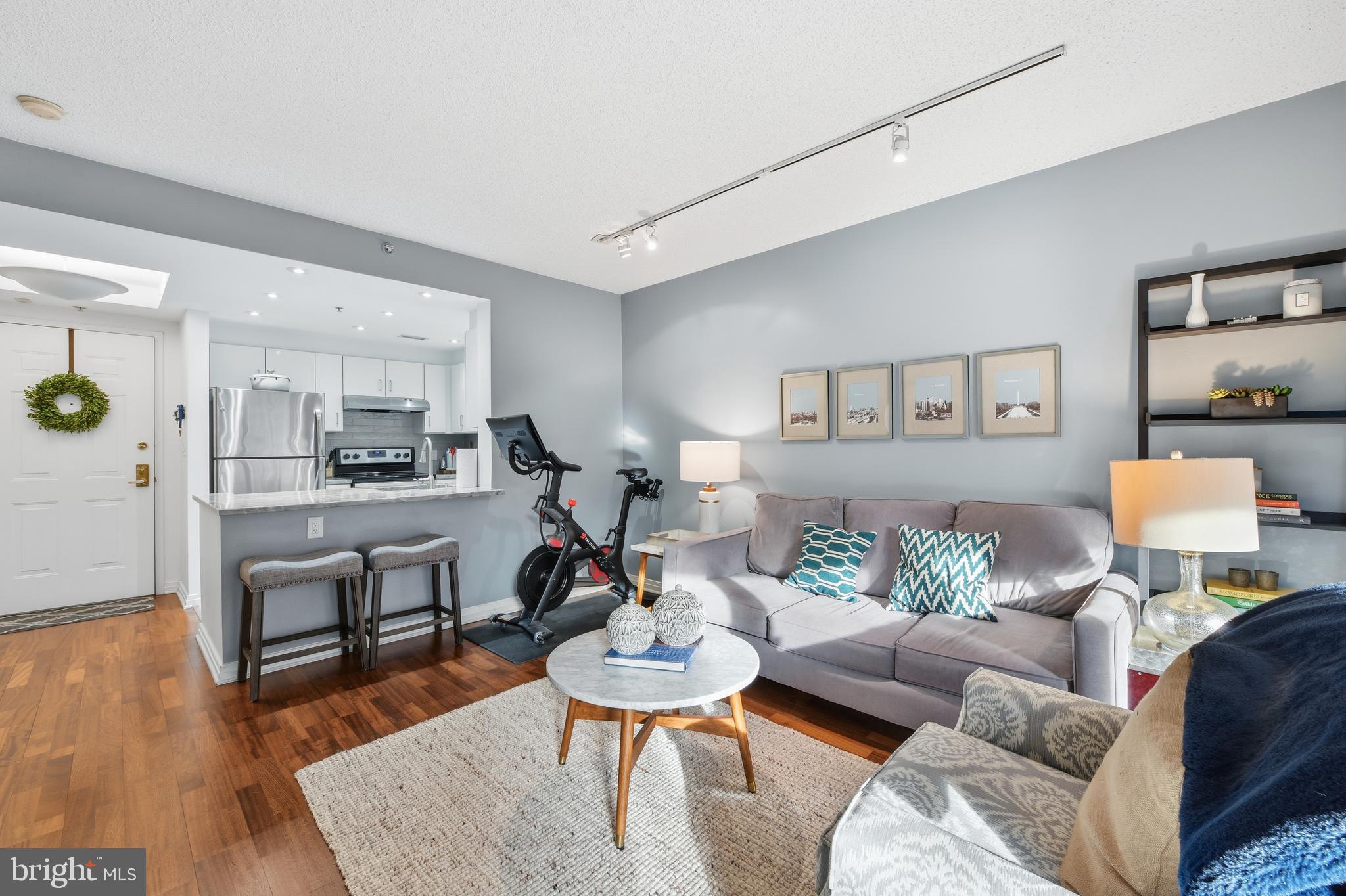 2301 N Street Northwest, Unit 212 Washington, DC 20037 - Photo 9 of 23 a living room with furniture and wooden floor