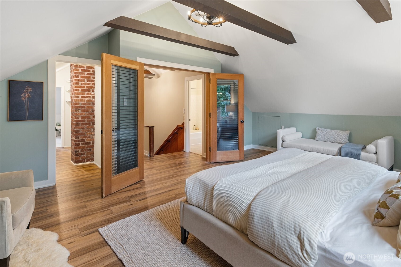 2463 26th Avenue East Seattle, WA 98112 - Photo 20 of 40 a spacious bedroom with a bed and wooden floor