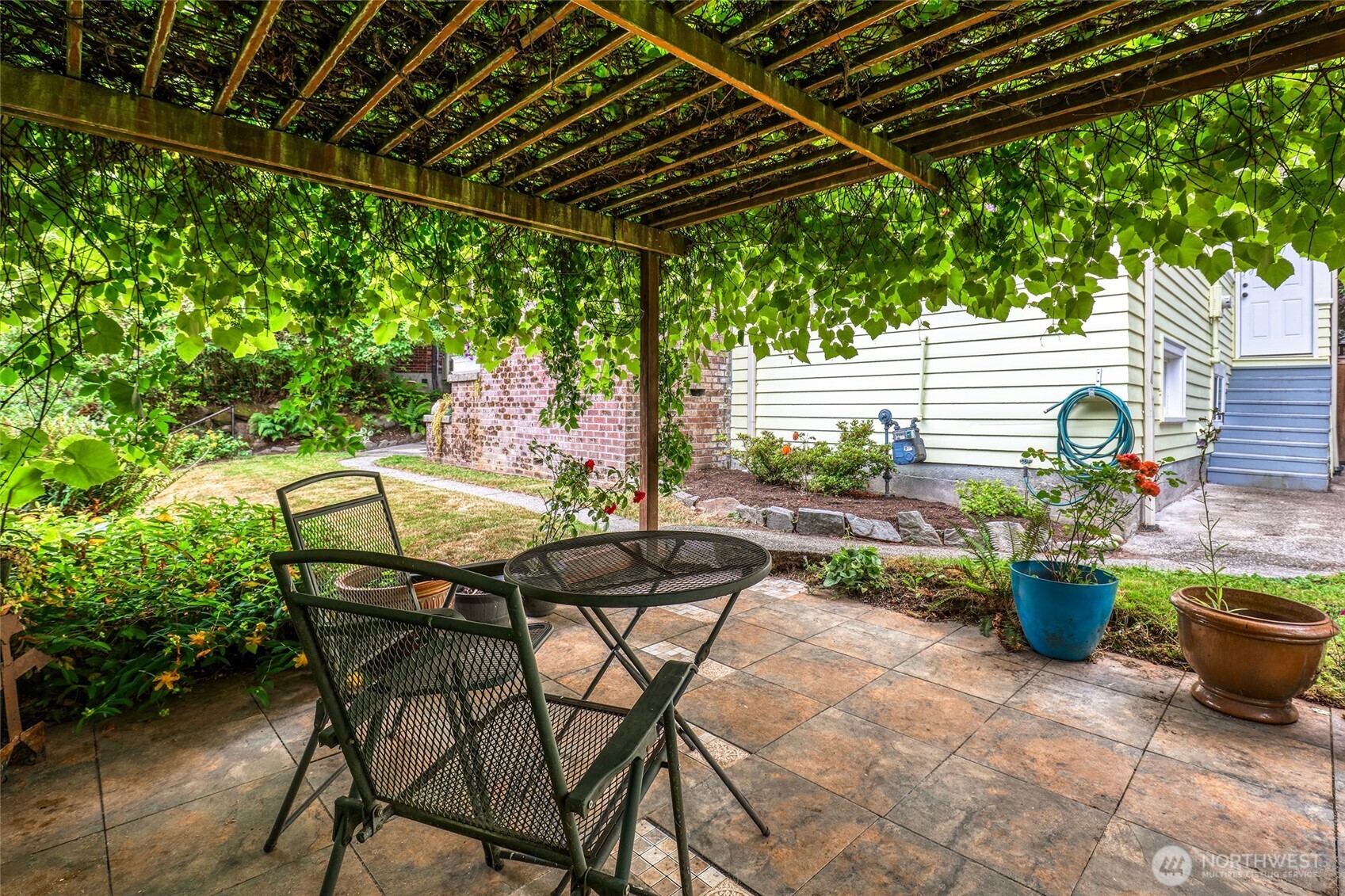 2463 26th Avenue East Seattle, WA 98112 - Photo 36 of 40 a backyard of a house with table and chairs