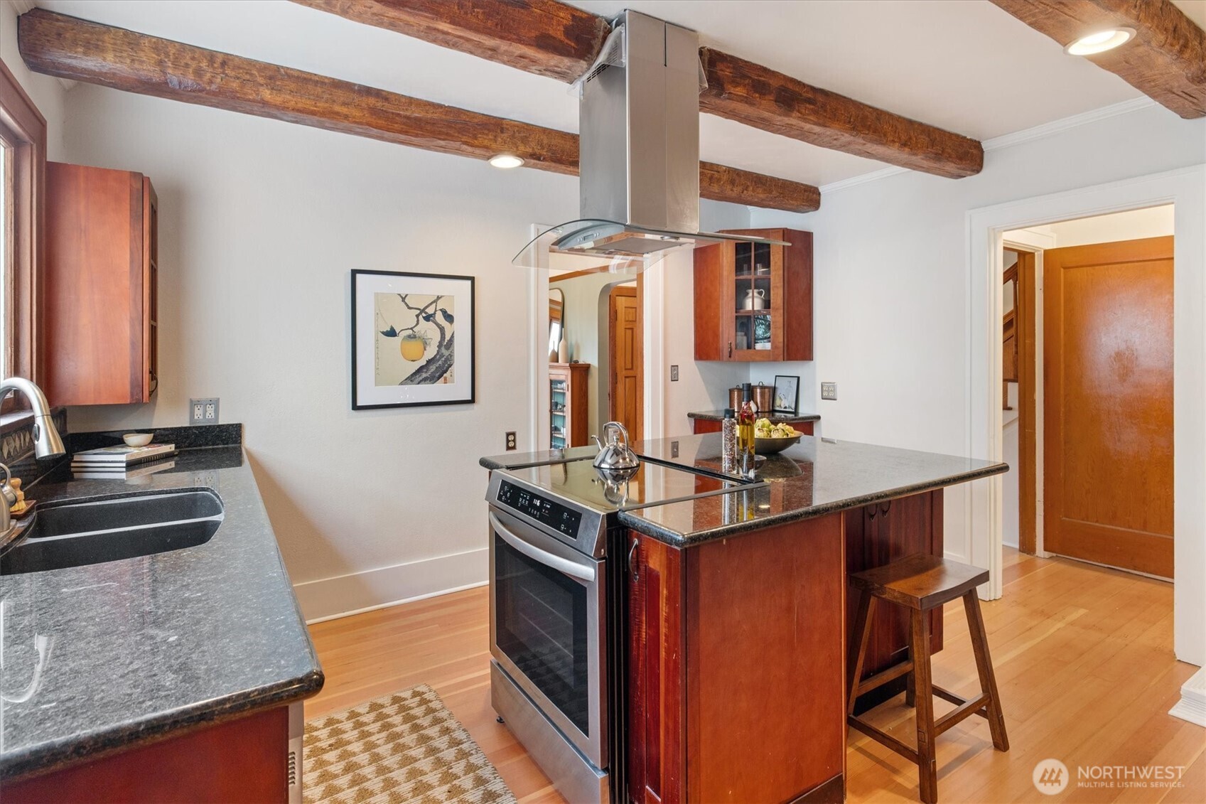 2463 26th Avenue East Seattle, WA 98112 - Photo 10 of 40 a kitchen with stainless steel appliances granite countertop a sink stove and cabinets