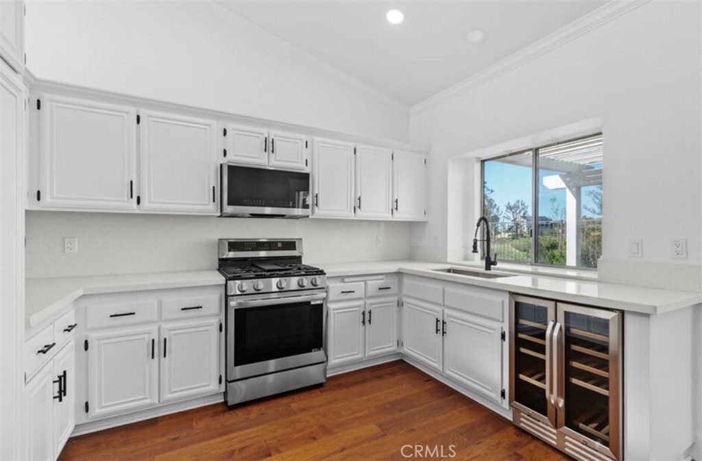 30894 Wellington Circle Temecula, CA 92591 - Photo 11 of 28 a kitchen with stainless steel appliances white cabinets and a stove top oven