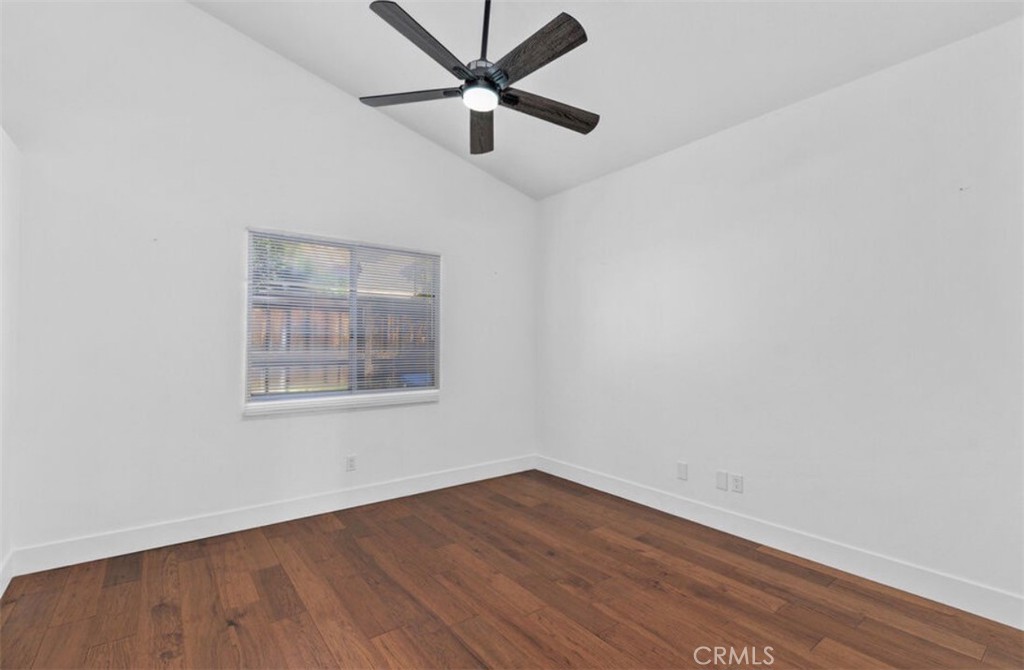 30894 Wellington Circle Temecula, CA 92591 - Photo 21 of 28 an empty room with wooden floor ceiling fan and window