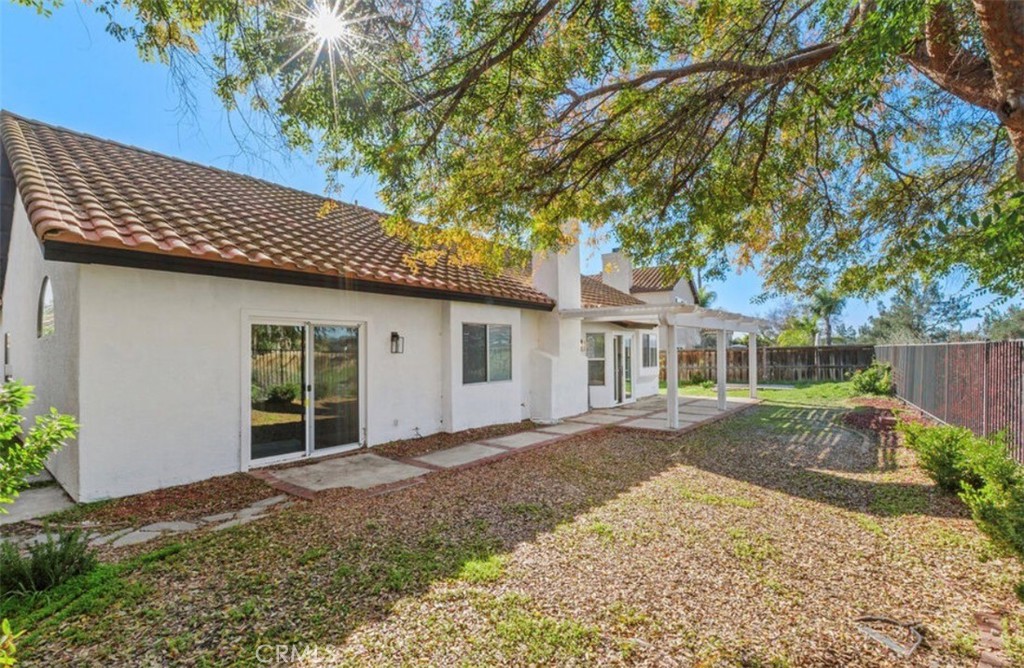 30894 Wellington Circle Temecula, CA 92591 - Photo 27 of 28 a front view of a house with a yard and potted plants